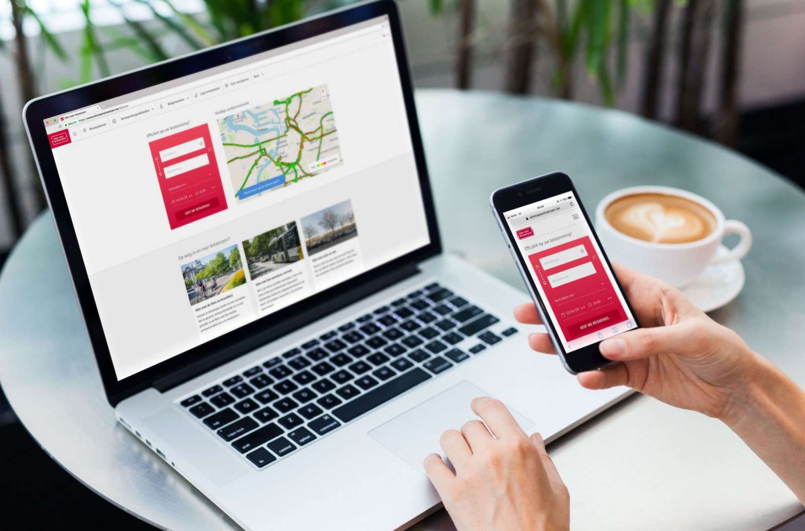 Person using the Smart Ways to Antwerp journey planner on a laptop and smartphone.