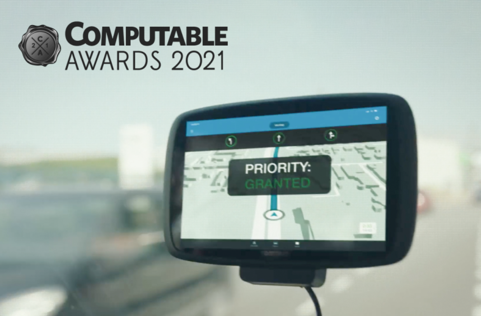 Computable Awards 2021 logo above an in-vehicle navigation screen showing the message Priority Granted on a route through an intersection.