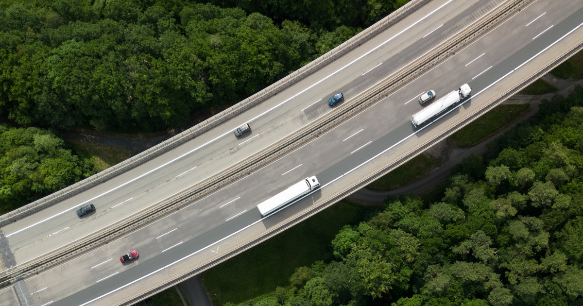 Aerial view of a highway viaduct with cars and trucks, cover visual for the Be-Mobile whitepaper on privacy and security in distance-based road charging