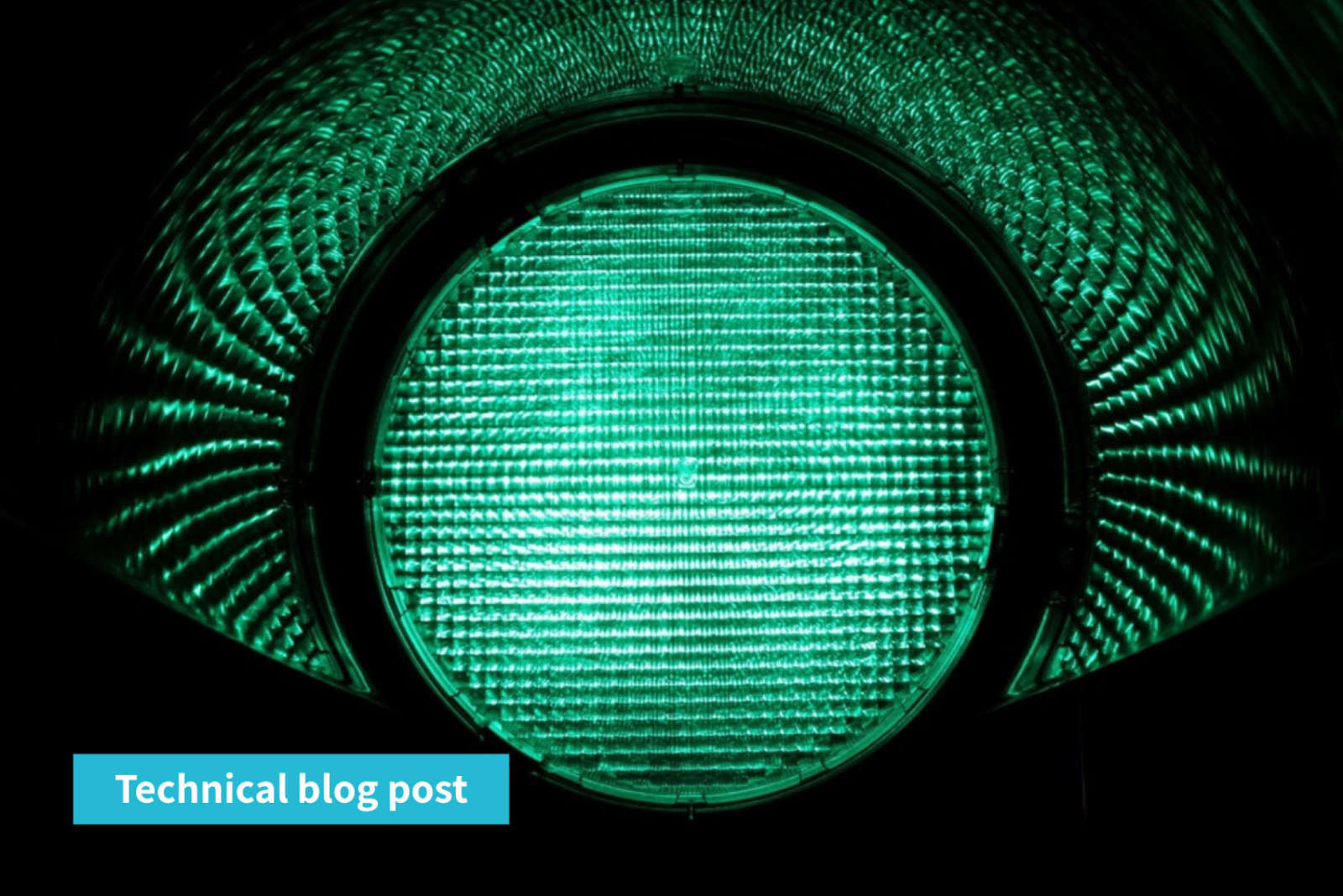 Close-up of an illuminated green traffic light lens in the dark, with a label reading Technical blog post.