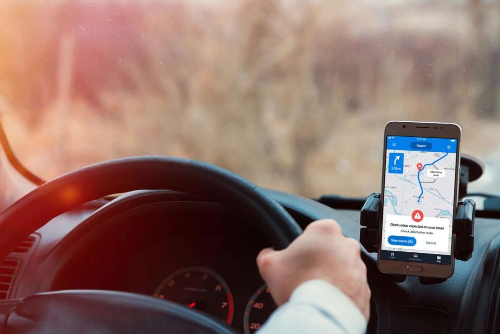 Smartphone mounted on a car dashboard showing an alternative route suggestion while driving