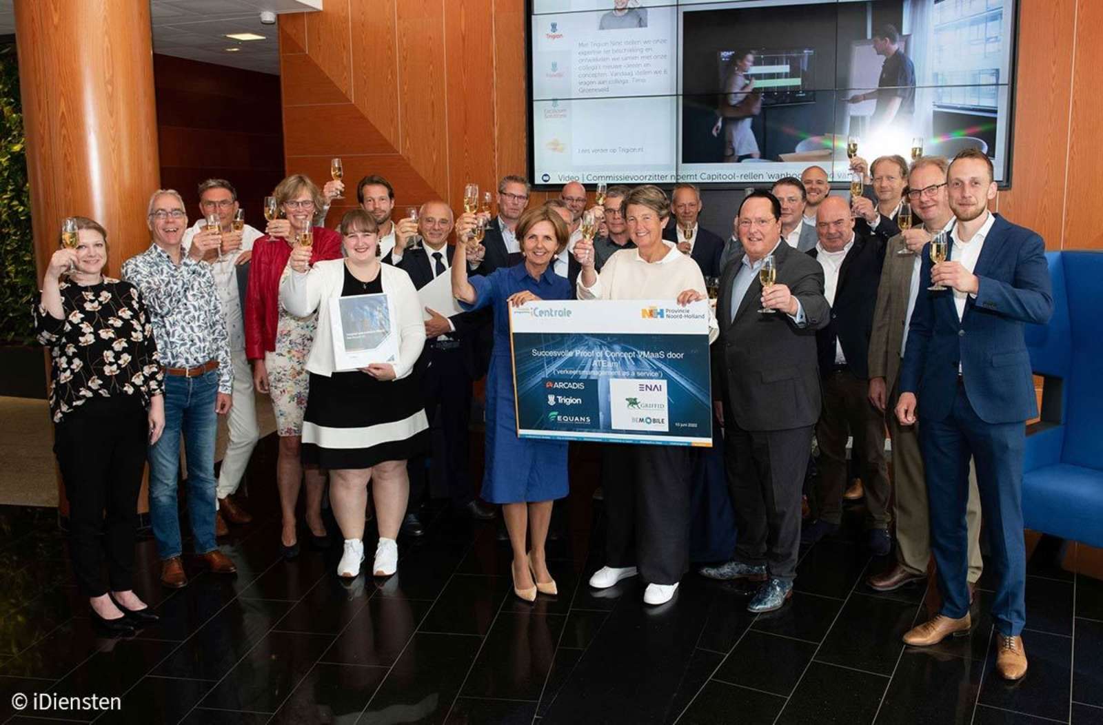 Group of ATEam consortium and Province of North Holland representatives raising a toast with a commemorative panel