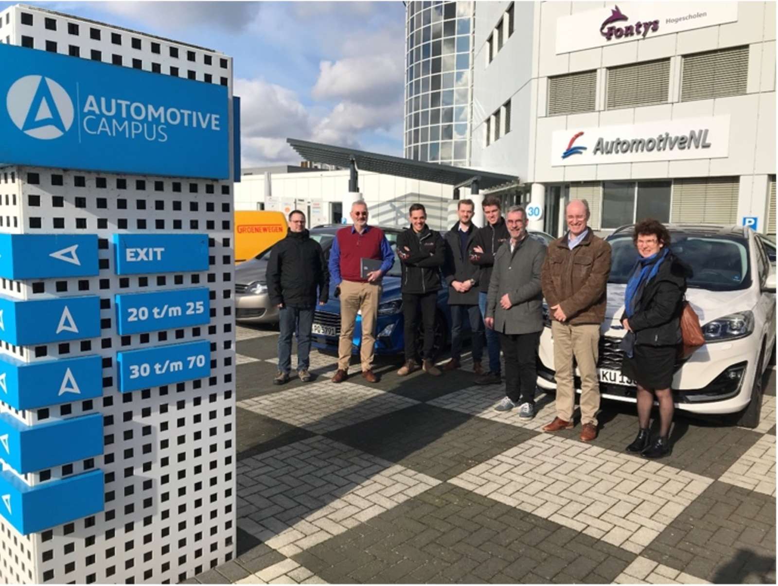 Group photo of the GLOSA project partners standing together outside at the Automotive Campus
