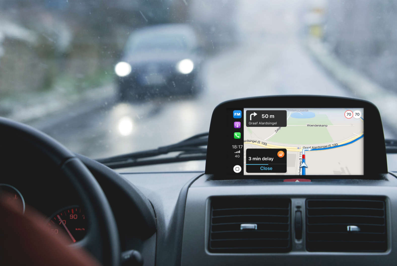 Car dashboard view with Flitsmeister in-car navigation showing turn-by-turn directions, the speed limit and a delay alert.