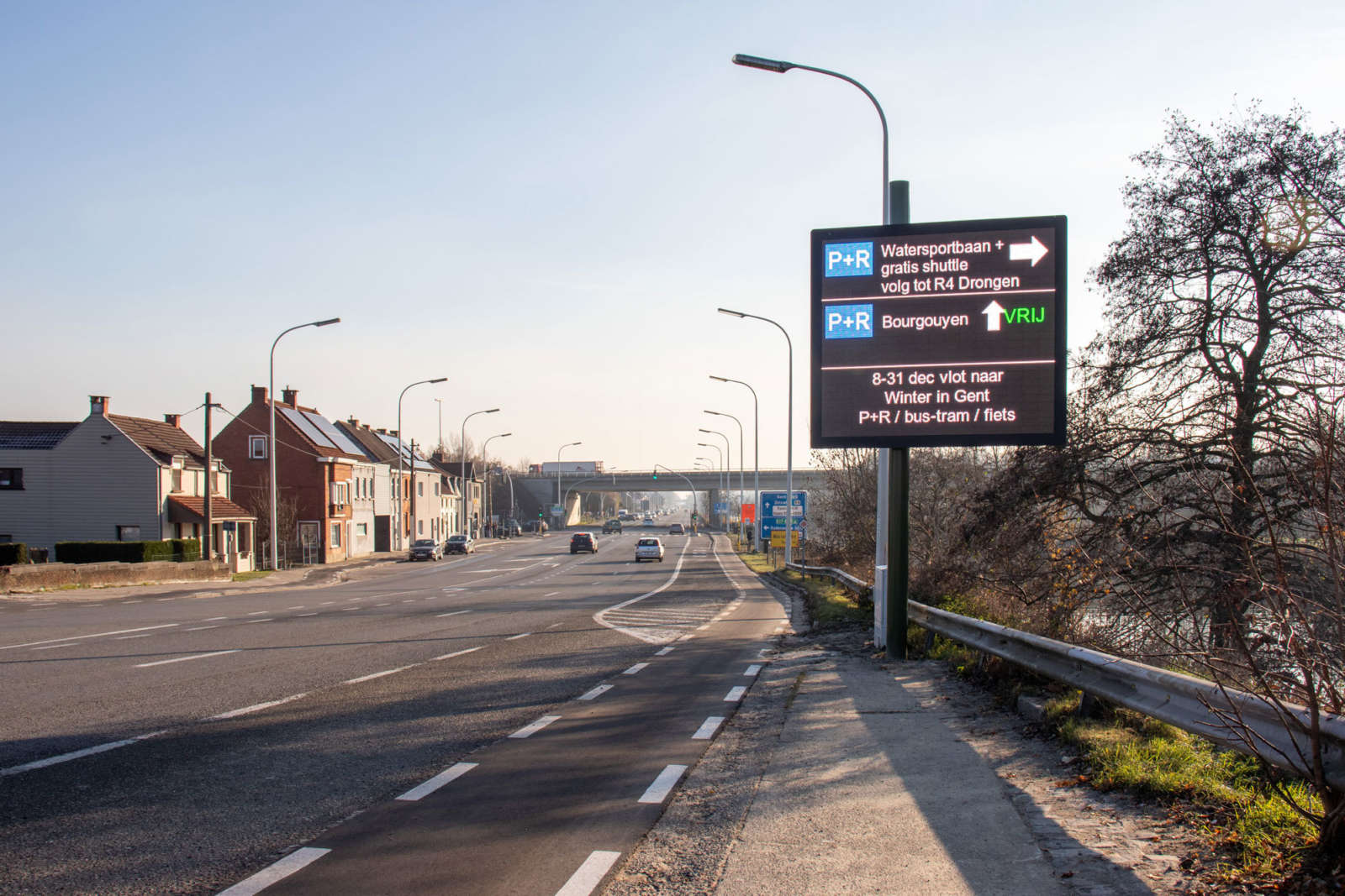LED P+R guidance sign along an arterial road into Ghent directing drivers to Watersportbaan and Bourgouyen park-and-ride sites