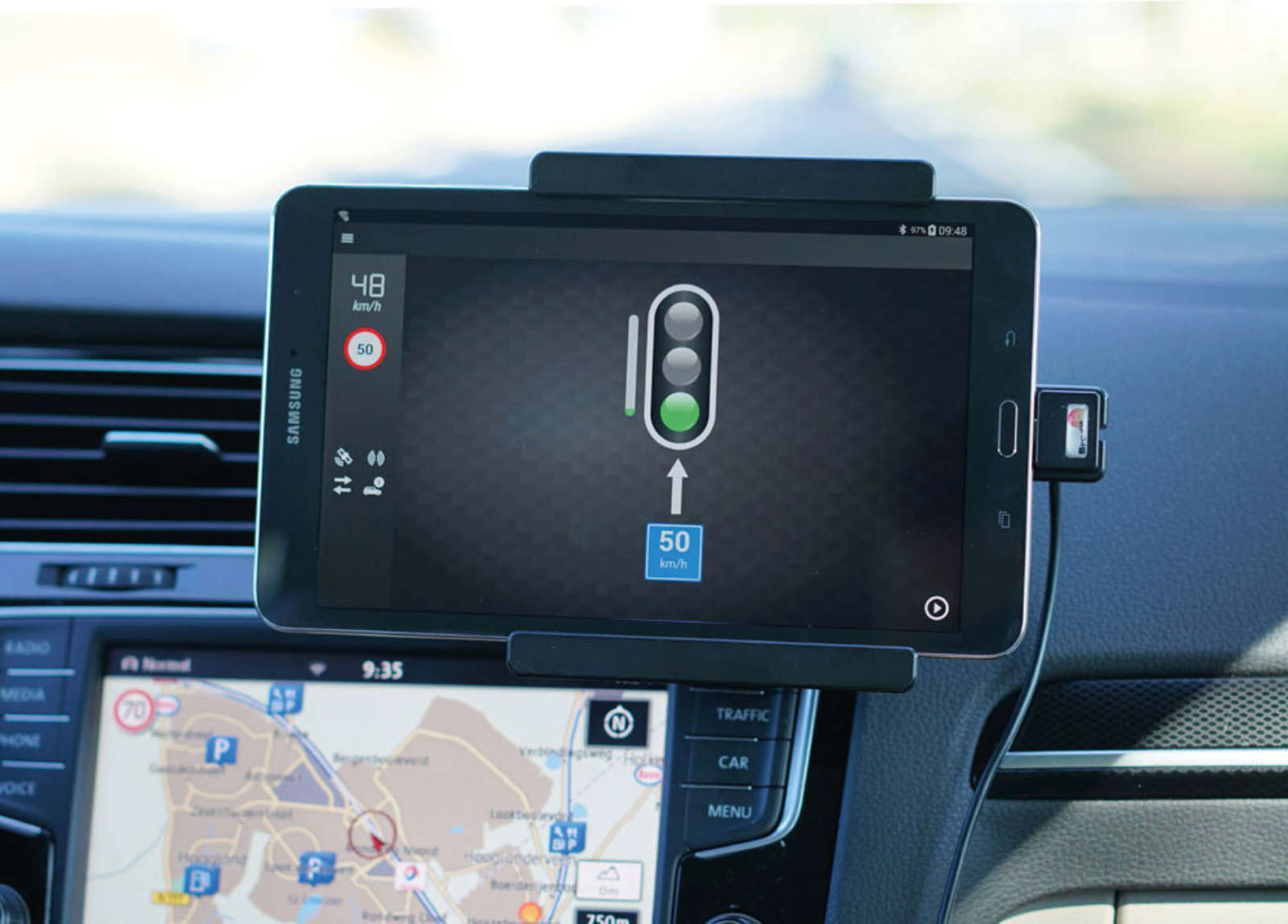 In-car tablet showing GLOSA speed advice next to built-in navigation — Be-Mobile C-ITS road test