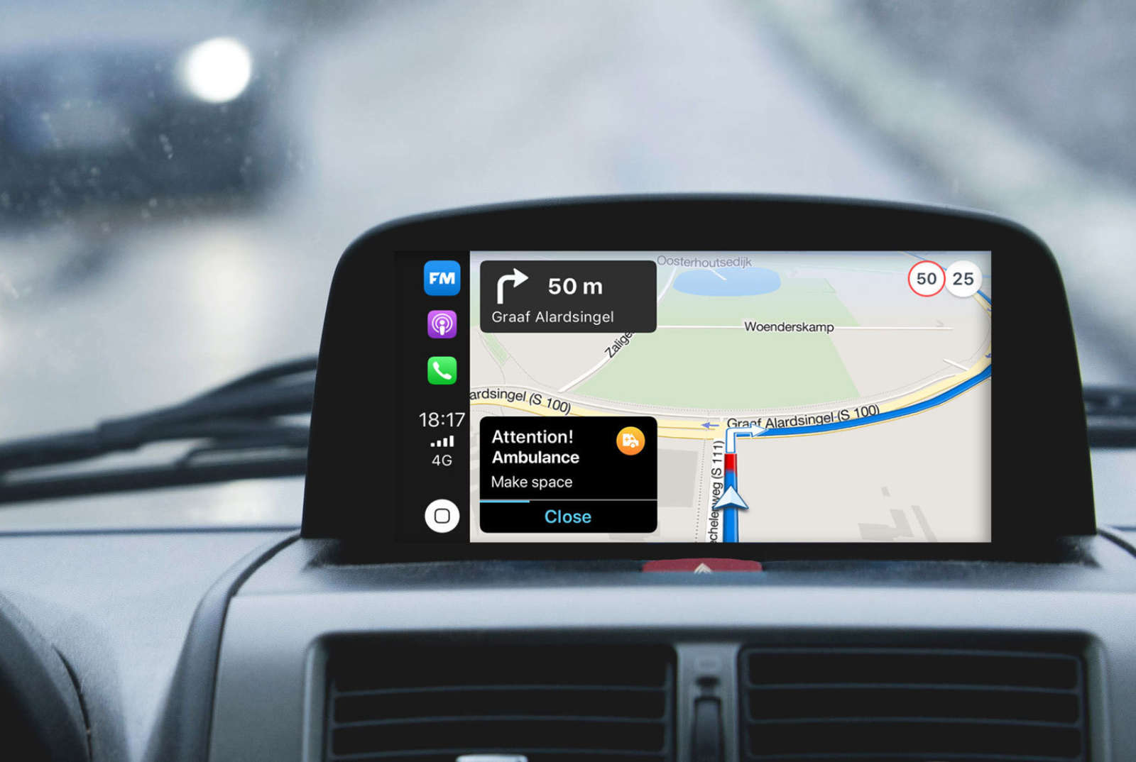 In-car dashboard showing a Flitsmeister ambulance warning — Be-Mobile Safety Priority Services road safety