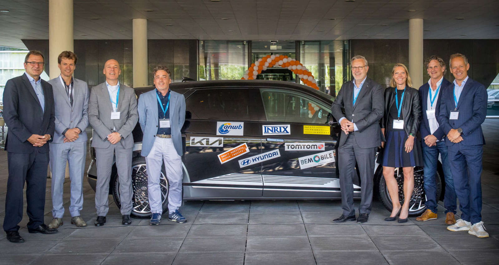 Group photo of the six Safety Priority Services partners next to a branded vehicle at the SPS launch