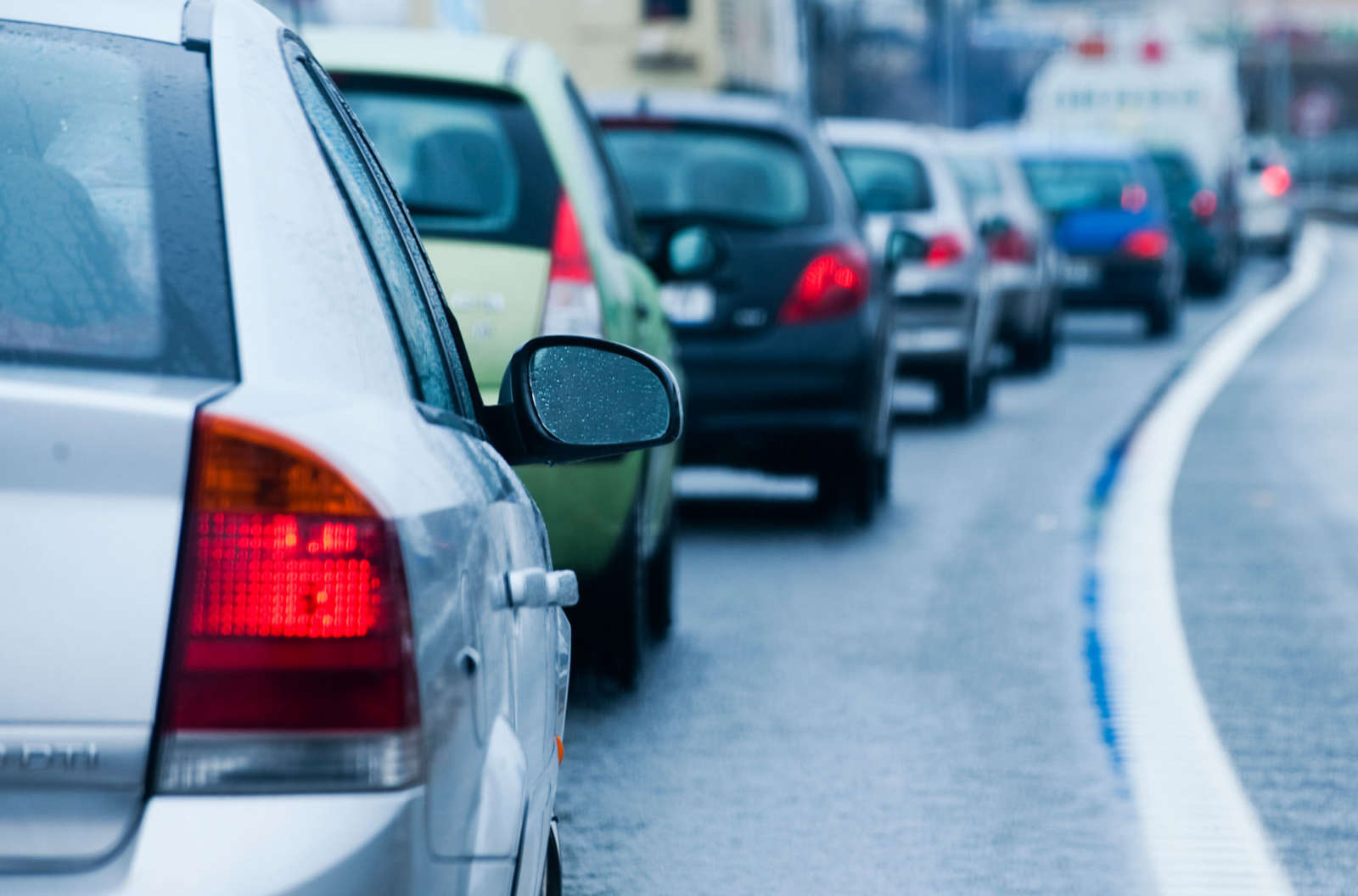 Cars queuing in slow-moving traffic on a multi-lane road.