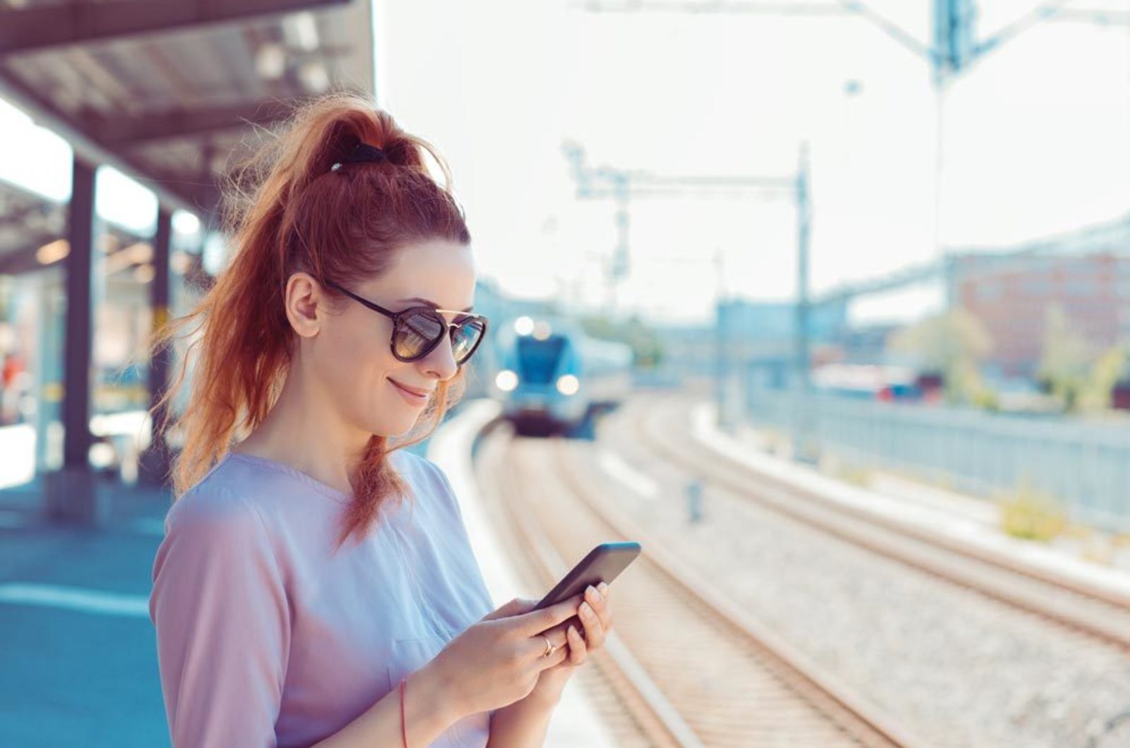 Train station platform woman smartphone