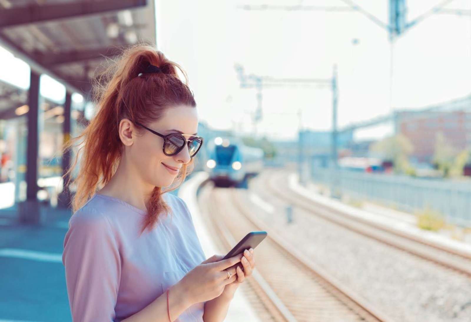 Train station platform woman smartphone